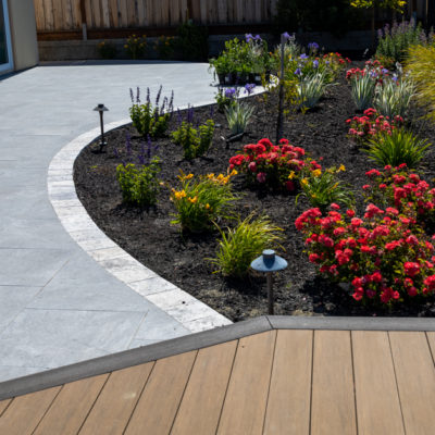 Porcelain Tile Paver Patio with Tumbled Travertine Stone Border