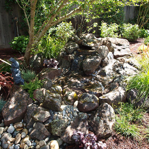 Natural moss rock into dry creek bed